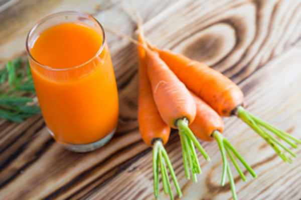 Стакан морковного сока и морковки